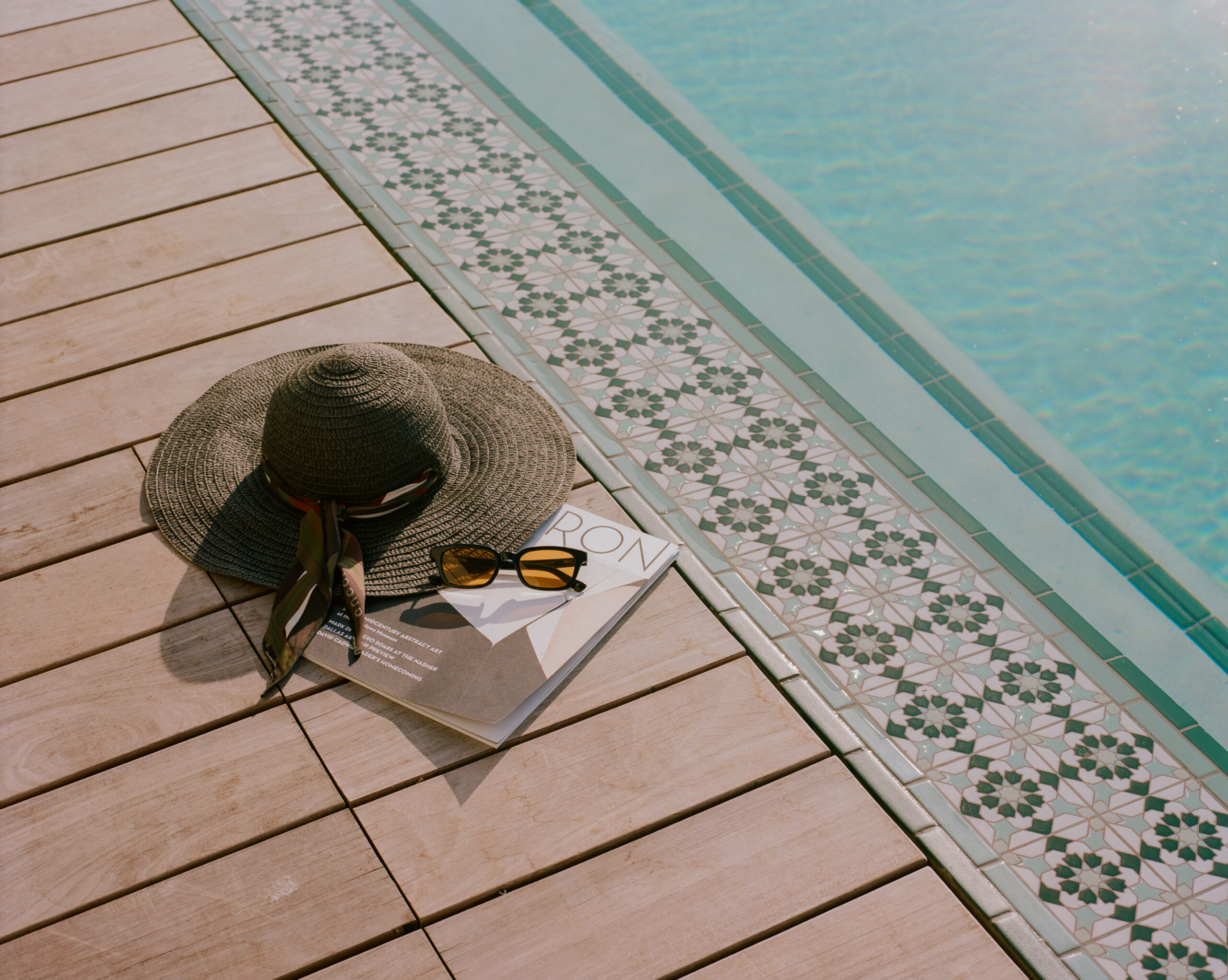 Hat and notebook by the Hotel Swexan pool